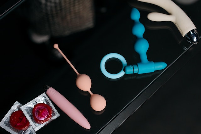 Table with anal sex toys and condoms