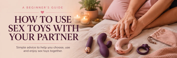 Sex toys and couple exploring together on a bed.