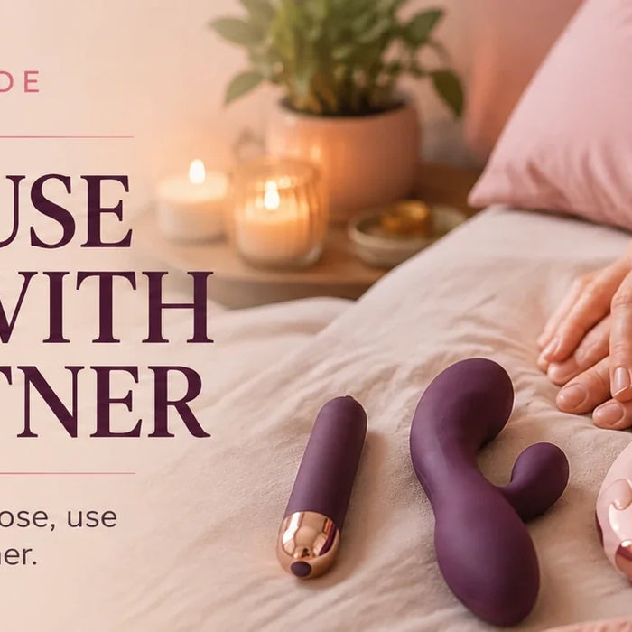 Sex toys and couple exploring together on a bed.