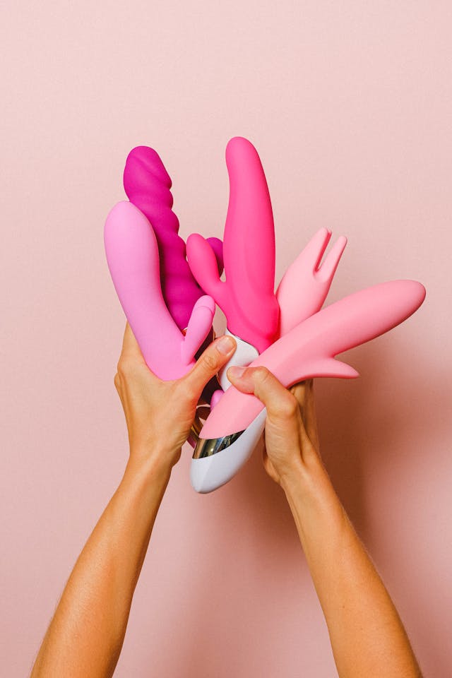 A woman holds a selection vibrators