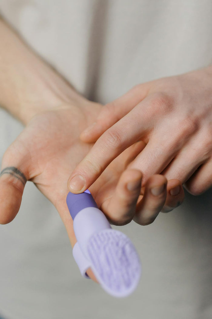 A woman touches a finger vibrator