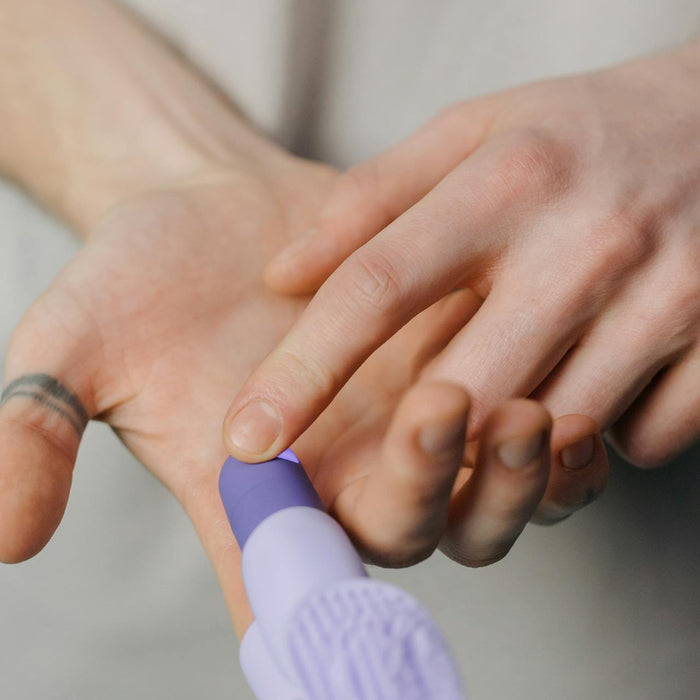 A woman touches a finger vibrator