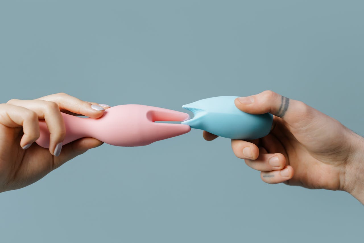 A couple touch two sex toys together