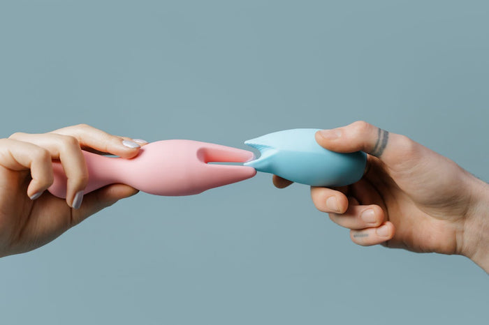 A couple touch two sex toys together