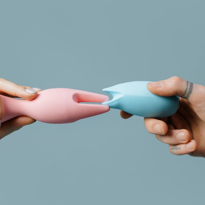 A couple touch two sex toys together