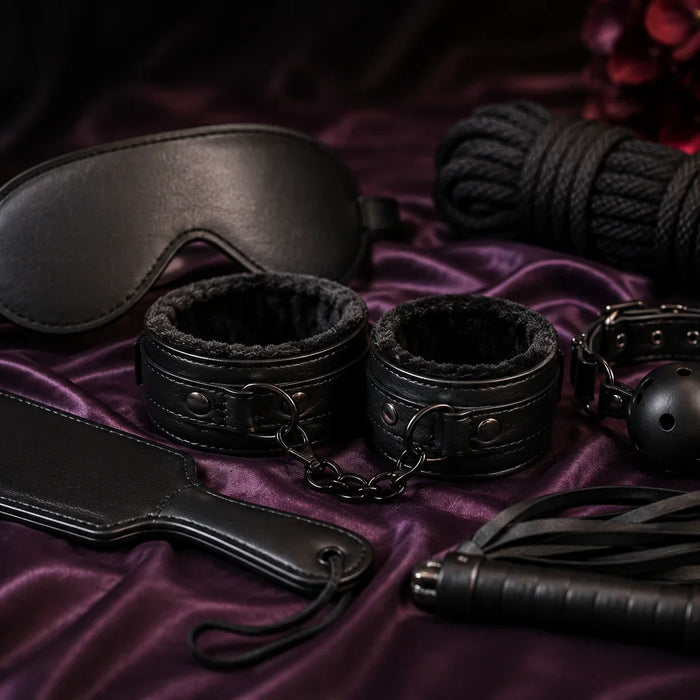 Beginner-friendly BDSM accessories including restraints, blindfold, paddle and ball gag arranged for a guide to bondage and kink in Australia.
