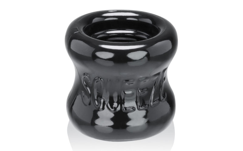 Front view of the OxBalls SQUEEZE Night Edition ball stretcher showing the hourglass profile.