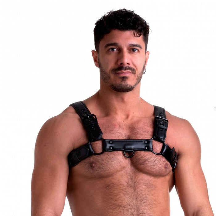A man wearing a black vegan bulldog harness with powder-coated rolling buckles and rivets.