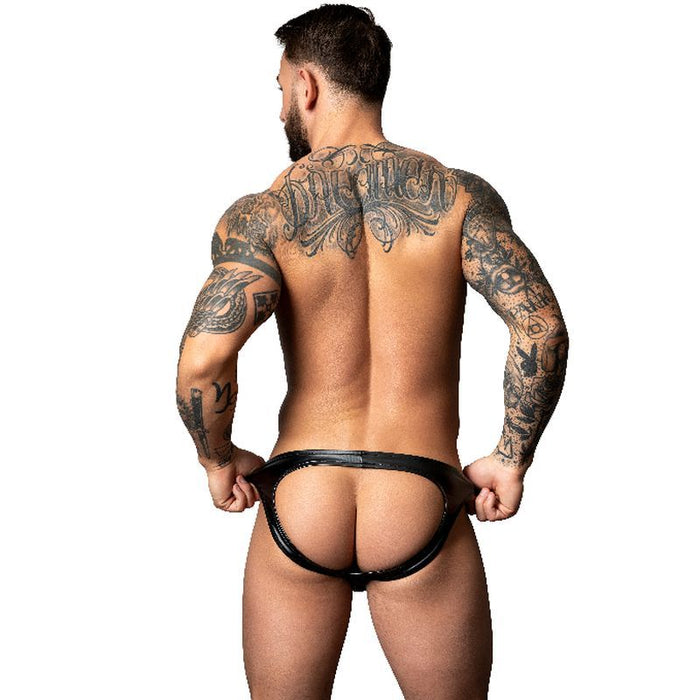 Man with tattoos wearing a black thong on a white background