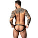 Man with tattoos wearing a black thong on a white background