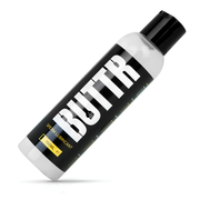 Angled view of the BUTTR White Cum Lubricant bottle and label
