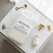 Wet stuff gold 5L on marble showing smaller bottle and funnel.