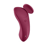 A wine red-colored panty vibe with a smooth, soft silicone exterior and a small magnetic attachment.