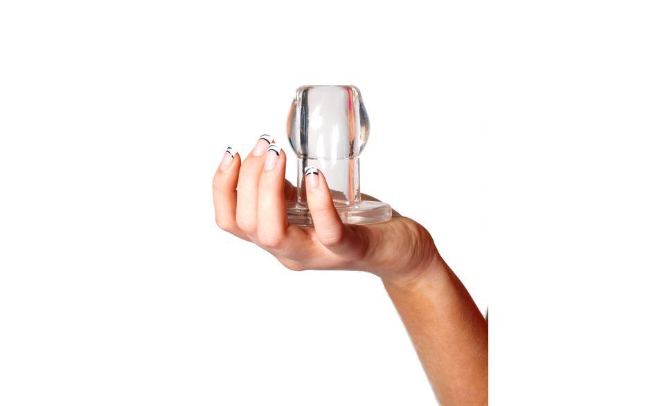 Perfect Fit Tunnel Butt Plug, Clear, being held in a woman's hand